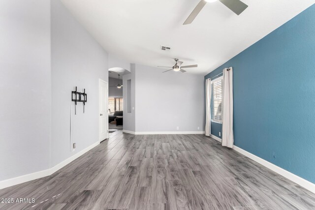 unfurnished living room featuring hardwood / wood-style floors and ceiling fan