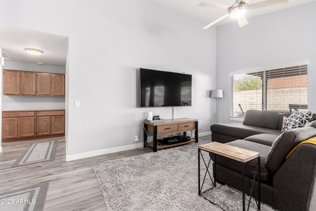 living room featuring ceiling fan and light wood-type flooring