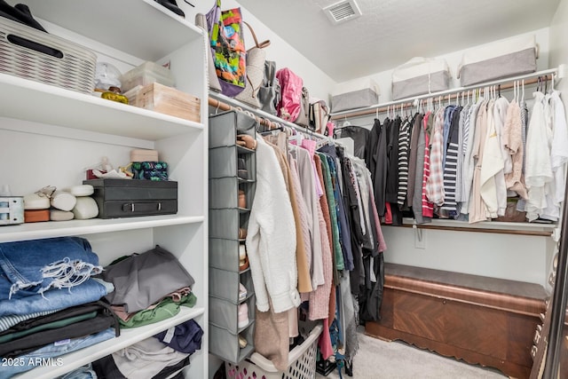 spacious closet featuring carpet flooring and visible vents