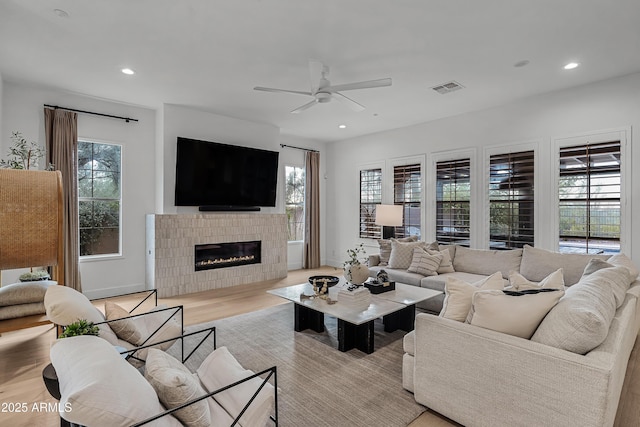 living room featuring light wood-type flooring and ceiling fan