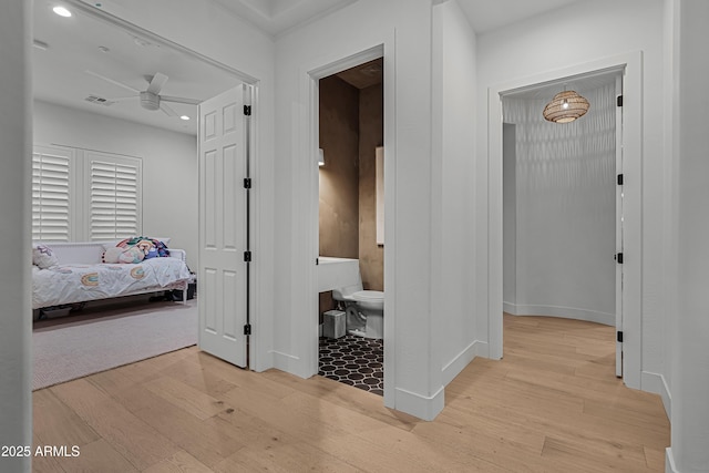 corridor with light hardwood / wood-style floors