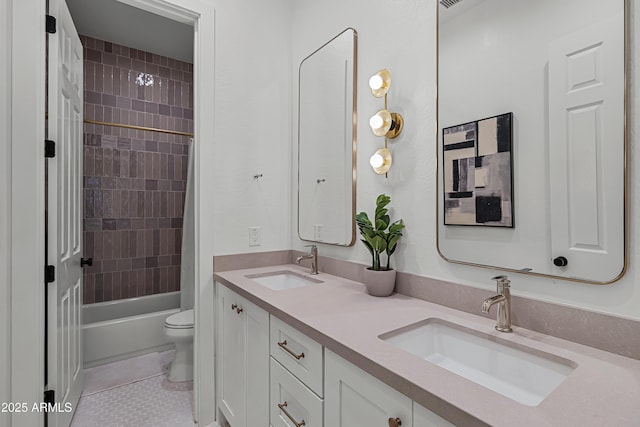 full bathroom featuring toilet, tile patterned flooring, vanity, and tiled shower / bath