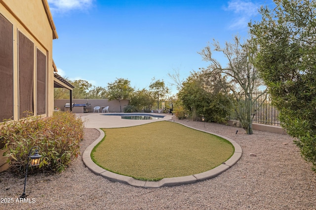 view of yard featuring a patio area and a fenced in pool