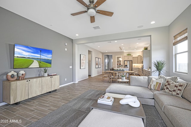 living room with dark wood-type flooring and ceiling fan