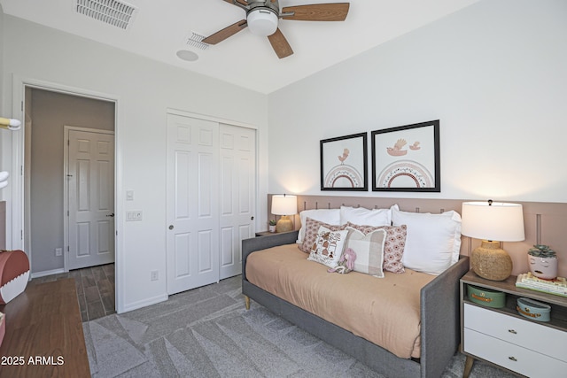 bedroom with dark hardwood / wood-style floors, ceiling fan, and a closet