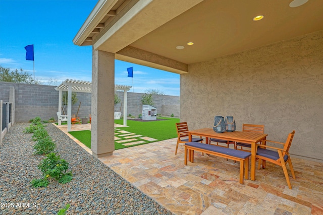 view of patio / terrace with a shed and a pergola