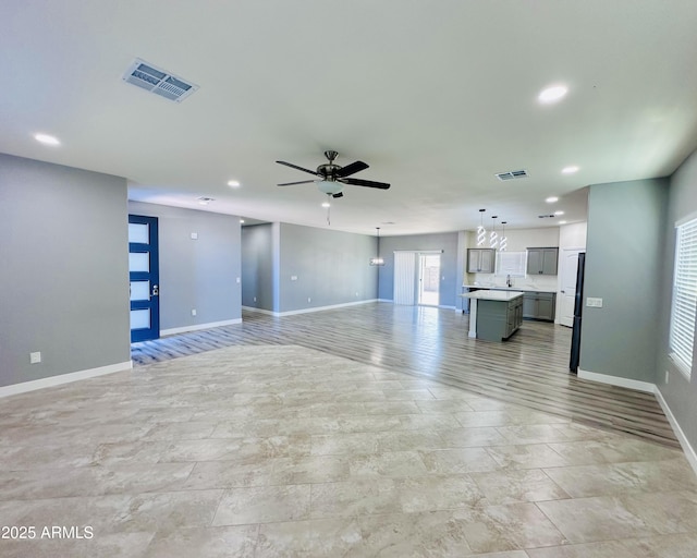 unfurnished living room with recessed lighting, visible vents, baseboards, and ceiling fan