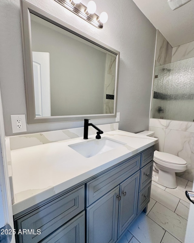 bathroom with walk in shower, marble finish floor, vanity, and toilet
