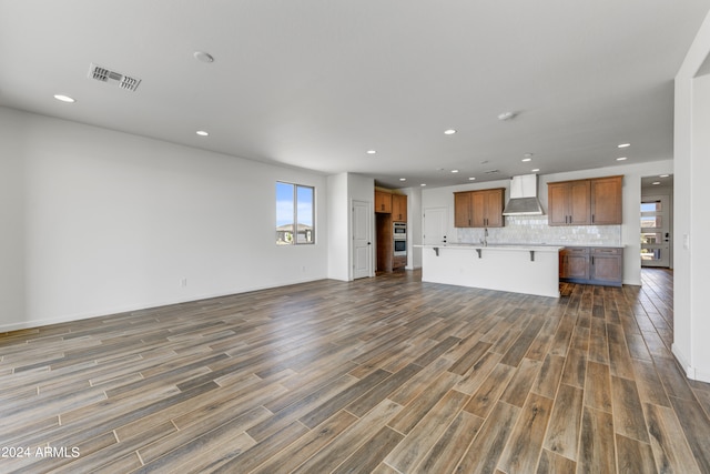 unfurnished living room featuring dark hardwood / wood-style floors