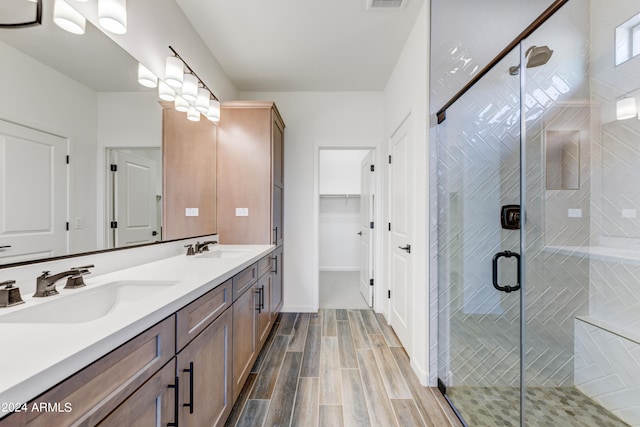 bathroom with an enclosed shower and vanity