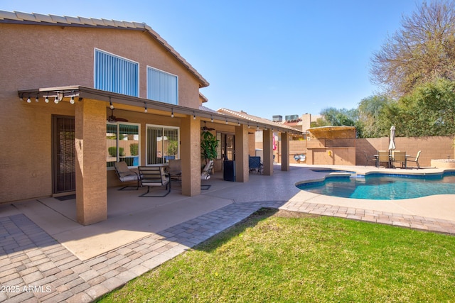 view of pool featuring a fenced in pool, a patio, fence, and a ceiling fan