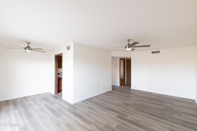 empty room with ceiling fan and light wood-type flooring