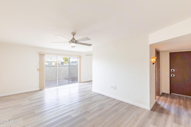 empty room with ceiling fan and light hardwood / wood-style flooring