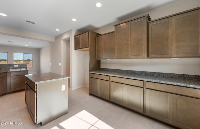 kitchen with a kitchen island and light tile patterned floors