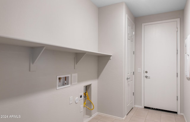 washroom featuring light tile patterned floors, hookup for a washing machine, and gas dryer hookup