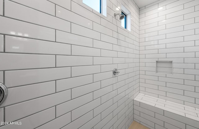 bathroom featuring a tile shower