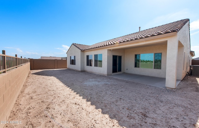 rear view of house with a patio area and cooling unit