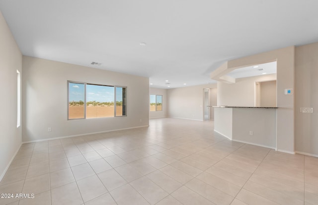 unfurnished room featuring light tile patterned floors