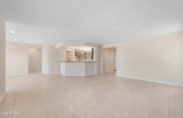 unfurnished living room featuring light tile patterned floors