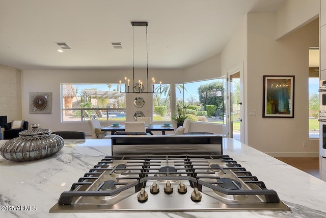 12225 E Cortez Dr, Scottsdale, AZ 85259 - kitchen featuring appliances with stainless steel finishes, light stone counters, visible vents, and a wealth of natural light