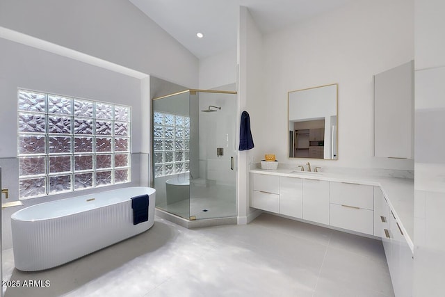 12225 E Cortez Dr, Scottsdale, AZ 85259 - bathroom with a freestanding tub, vanity, vaulted ceiling, a stall shower, and tile patterned flooring