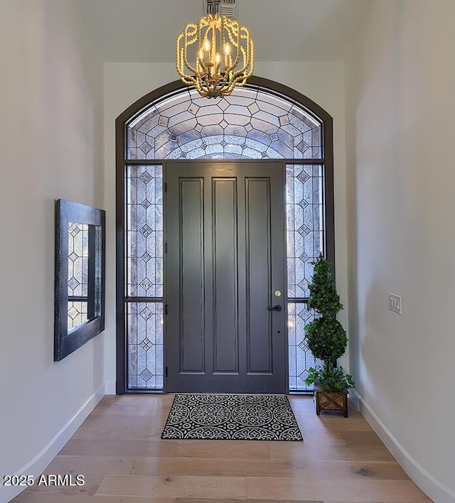 12225 E Cortez Dr, Scottsdale, AZ 85259 - foyer featuring wood finished floors, an inviting chandelier, baseboards, and plenty of natural light