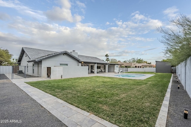 11942 N 95th St, Scottsdale, AZ 85260 - rear view of house with a fenced backyard, stucco siding, a patio area, and a yard