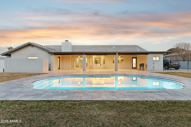11942 N 95th St, Scottsdale, AZ 85260 - pool at dusk featuring a patio, fence, a fenced in pool, and a yard