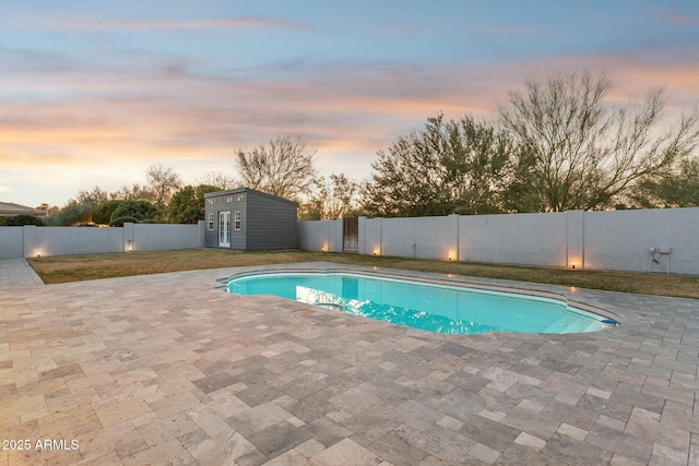11942 N 95th St, Scottsdale, AZ 85260 - pool at dusk with a patio, a fenced backyard, and an outdoor structure