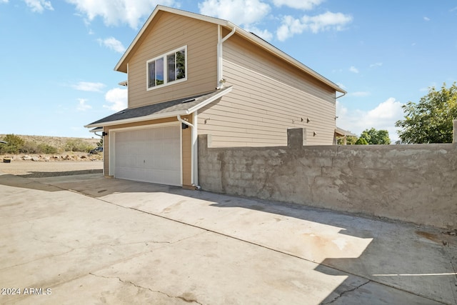 view of property exterior with a garage