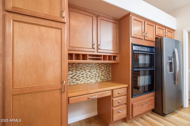 kitchen featuring dobule oven black, built in study area, stainless steel fridge with ice dispenser, open shelves, and backsplash