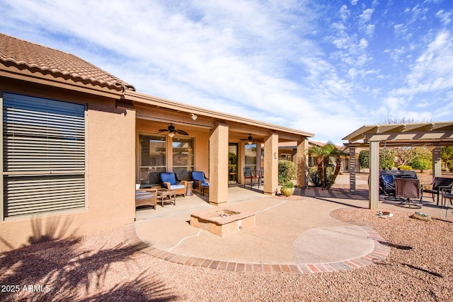 view of patio / terrace featuring an outdoor fire pit and ceiling fan