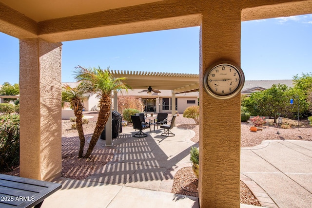 view of patio with a ceiling fan, outdoor dining space, and a pergola