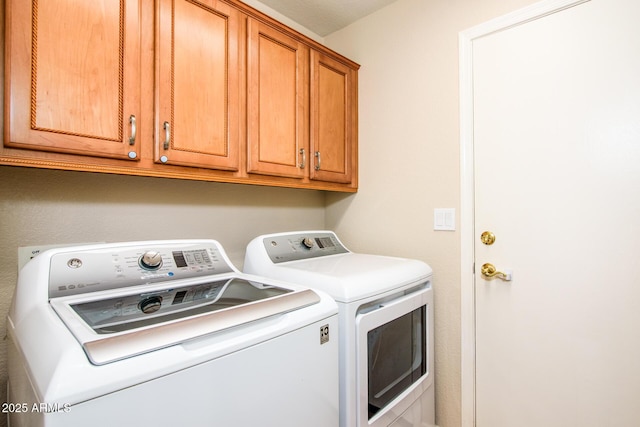 laundry room with cabinet space and independent washer and dryer