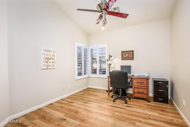 office with light wood finished floors, visible vents, vaulted ceiling, ceiling fan, and baseboards