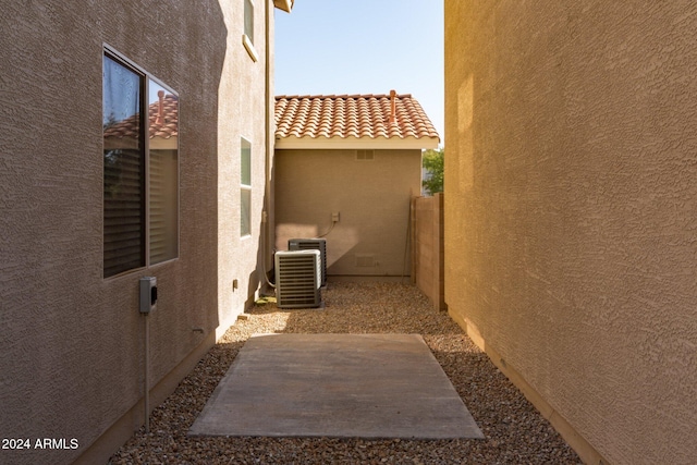 view of property exterior featuring a patio and cooling unit