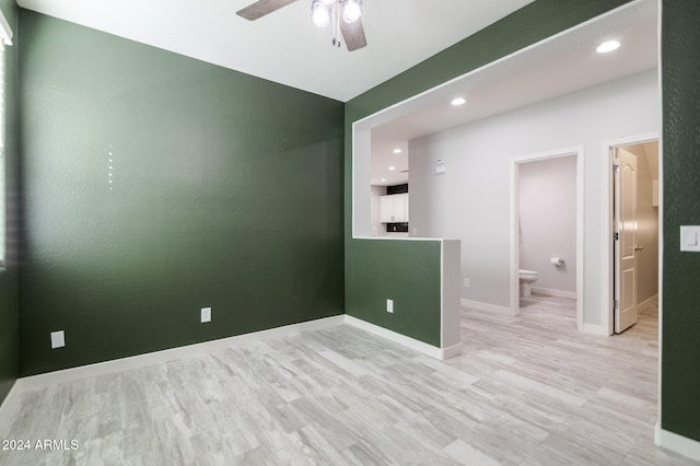 spare room with light hardwood / wood-style floors and ceiling fan