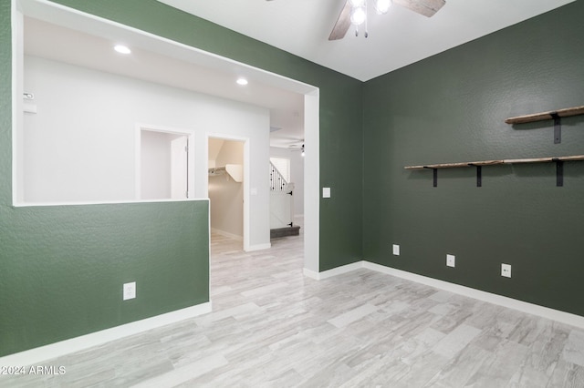 spare room featuring light wood-type flooring and ceiling fan