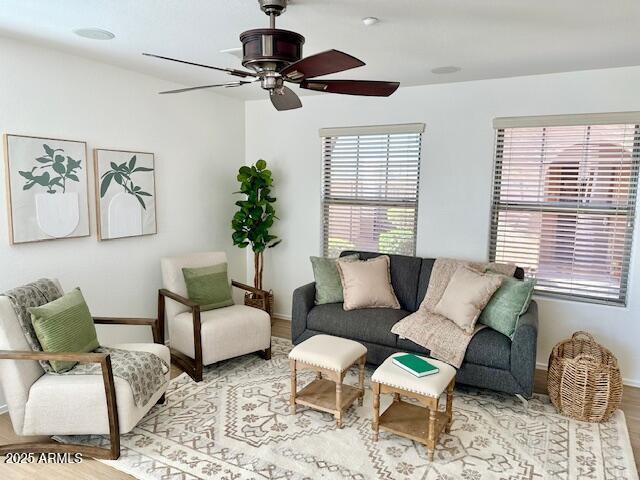 living room with ceiling fan and light hardwood / wood-style flooring