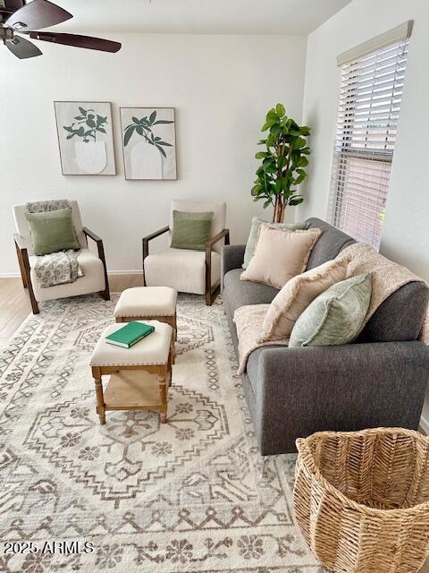 living room featuring ceiling fan and hardwood / wood-style floors