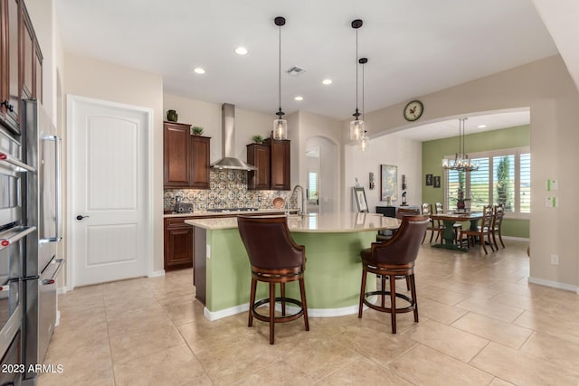 4149 N Brigadier Dr, Florence, AZ 85132 - kitchen with pendant lighting, light countertops, a center island with sink, and wall chimney exhaust hood