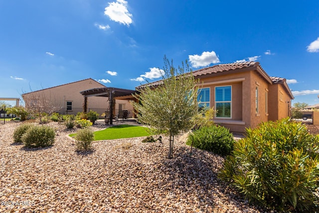 4149 N Brigadier Dr, Florence, AZ 85132 - back of house featuring stucco siding, fence, a tiled roof, and a pergola