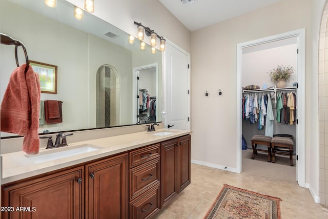 4149 N Brigadier Dr, Florence, AZ 85132 - bathroom featuring double vanity, visible vents, a walk in closet, and a sink