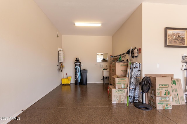 4149 N Brigadier Dr, Florence, AZ 85132 - garage featuring tankless water heater, a sink, and baseboards