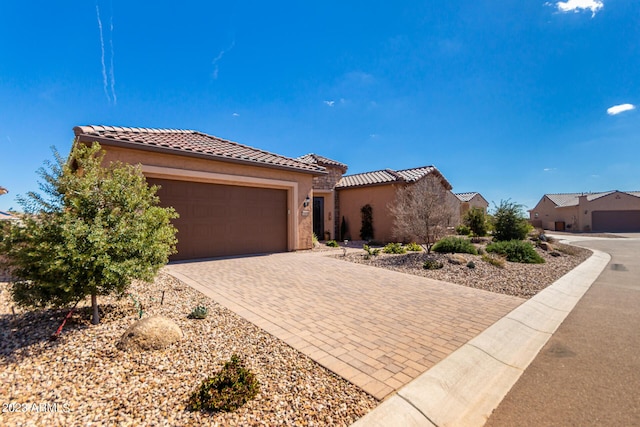 4149 N Brigadier Dr, Florence, AZ 85132 - view of front of home with a tiled roof, decorative driveway, an attached garage, and stucco siding