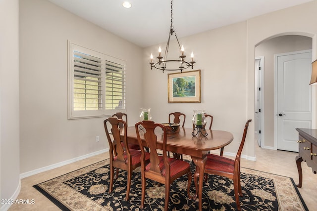 4149 N Brigadier Dr, Florence, AZ 85132 - dining area with a chandelier, tile patterned flooring, arched walkways, and baseboards
