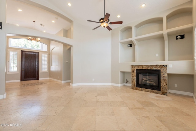 2701 E Caldwell St, Phoenix, AZ 85042 - unfurnished living room featuring a tiled fireplace, baseboards, ceiling fan with notable chandelier, and recessed lighting