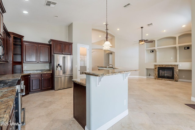 2701 E Caldwell St, Phoenix, AZ 85042 - kitchen with visible vents, a ceiling fan, appliances with stainless steel finishes, and a breakfast bar