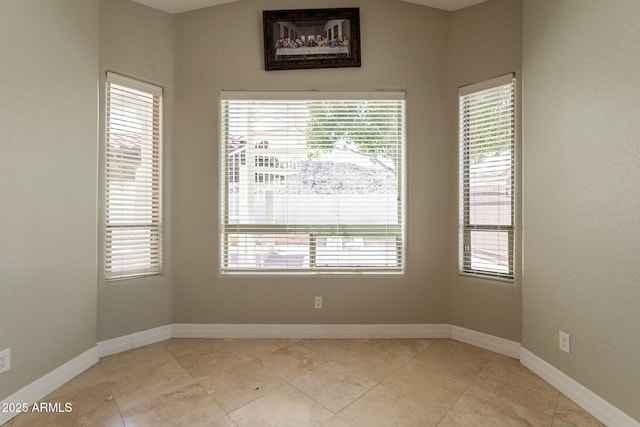 2701 E Caldwell St, Phoenix, AZ 85042 - spare room featuring baseboards and light tile patterned floors