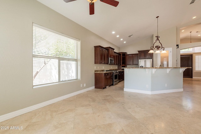 2701 E Caldwell St, Phoenix, AZ 85042 - kitchen featuring a breakfast bar, ceiling fan, light stone counters, vaulted ceiling, and stainless steel appliances